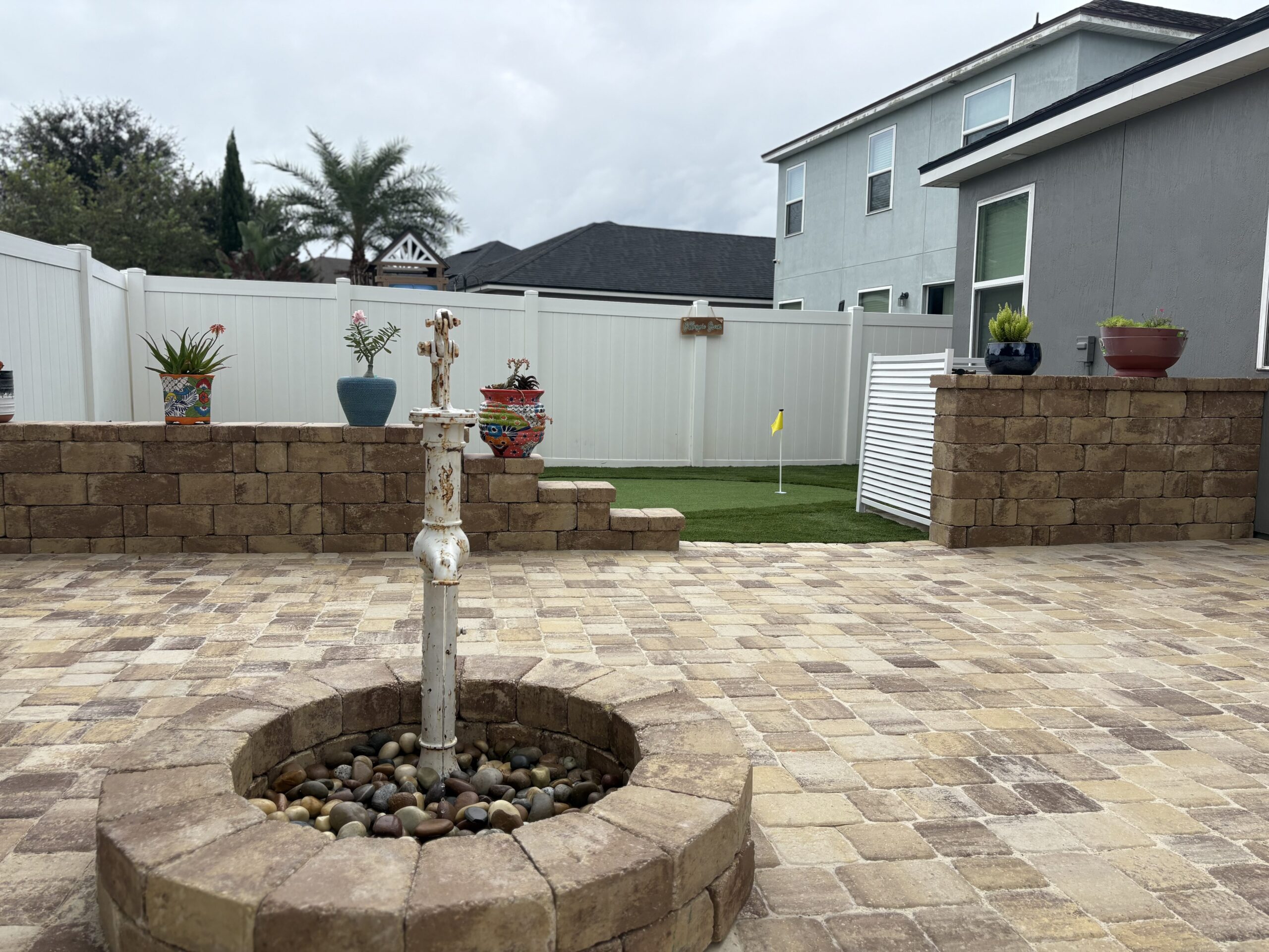 Custom water feature built into a backyard landscape in St. Johns County, FL