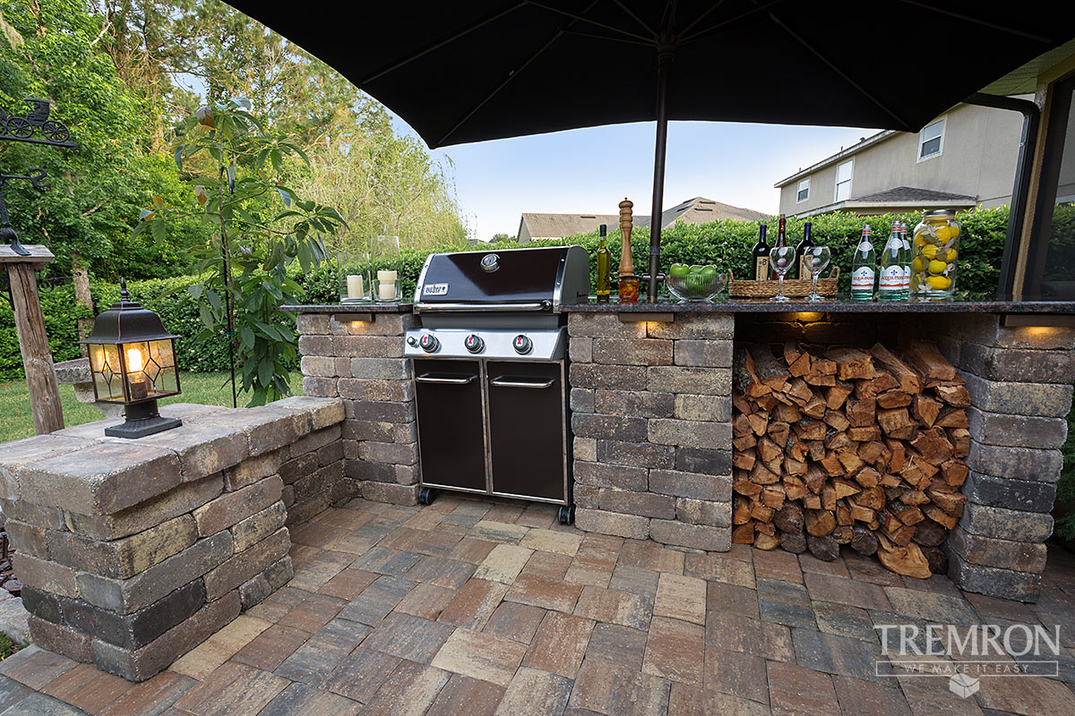 Custom outdoor kitchen with a built-in grill and counter seating in St. Augustine, FL