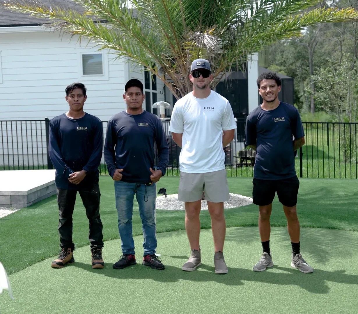 Griffin Helm and the Helm Outdoor Solutions crew on a backyard putting green