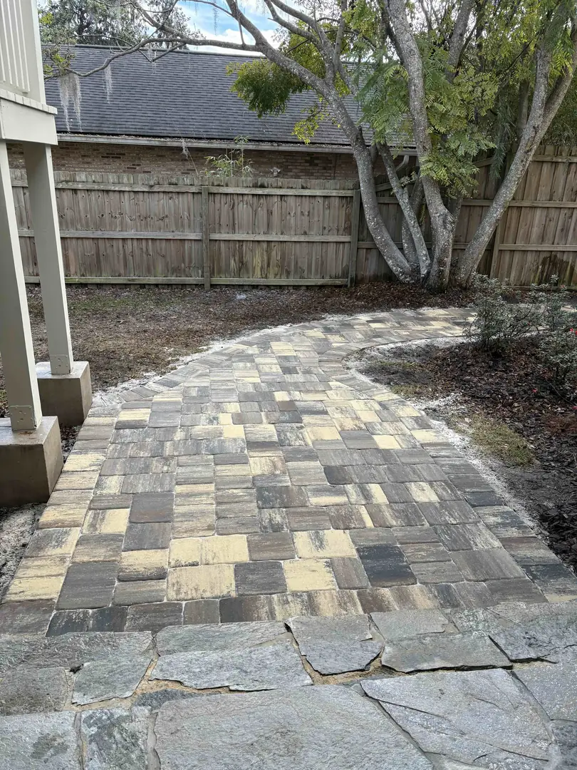 Paver walkway transitioning to flagstone along a shaded side yard in St. Augustine, FL